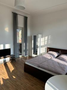 a bedroom with a bed and a flat screen tv at Villa Rathenow in Rathenow