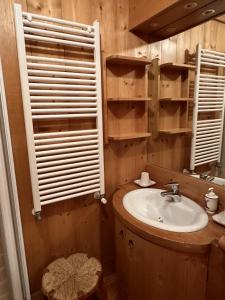 a bathroom with a sink and a mirror at Pecol Cozy Apartment R&R in Cortina dʼAmpezzo