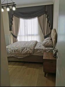 a bedroom with a large bed with a window at شقة سياحية مطلة على البحر in Istanbul