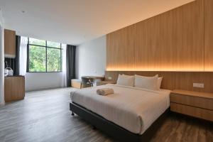 a bedroom with a large bed and a desk at Macalister 288 in George Town