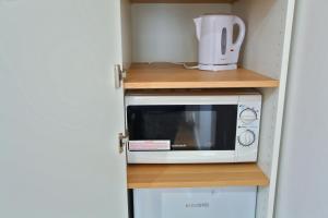 a microwave sitting on a shelf in a kitchen at St David in Barrow in Furness