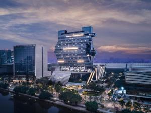 a tall building with lights on in a city at Langham Place Guangzhou - Walking distance to Canton Fair in Guangzhou