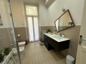 a bathroom with a sink and a toilet and a mirror at Rome Holiday Home in Rome