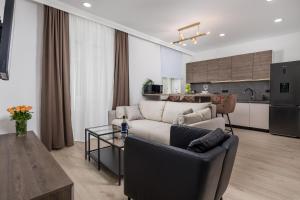 リエカにあるArea Luxury Spa Apartmentのリビングルーム(ソファ、テーブル付)、キッチンが備わります。