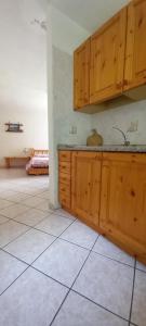 a kitchen with wooden cabinets and a tile floor at Le Vieux Creton, Rhêmes-Saint-Georges in Rhemes-Saint-Georges +24 photos