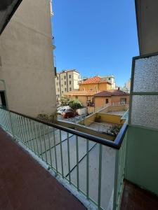 a balcony with a view of a street and buildings at CASA BENEDETTA Nuovo bilocale 100 metri dal mare in Alassio