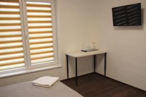 a room with a white table and a window at Pakalnės sodyba in Skverbai