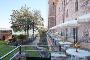 a row of tables on the side of a building at Château de Théoule Hôtel & Spa in Théoule-sur-Mer