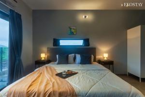 a bedroom with a large bed with a tray on it at EKOSTAY - Neptune Villa in Igatpuri