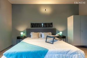 a bedroom with a large bed with two side tables at EKOSTAY - Neptune Villa in Igatpuri