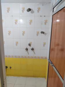 a bathroom with a shower with crabs on the wall at Madhuban Homestay 1 Ujjain in Ujjain