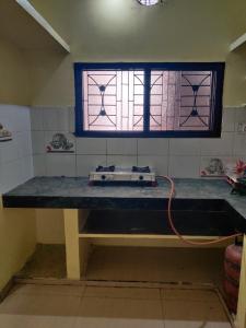 a room with a table with a window at Madhuban Homestay 1 Ujjain in Ujjain