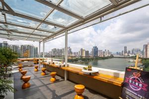 a restaurant with a view of a river and buildings at MARHAUS Hotel Beijing Road Tian-Zi Pier Store in Guangzhou