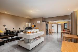 a kitchen with a counter with food on it at MARHAUS Hotel Beijing Road Tian-Zi Pier Store in Guangzhou