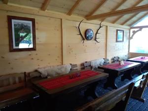 a dining room with two tables in a cabin at Domek z Góralską Duszą Śleboda in Jurgów