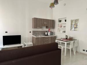 a living room with a couch and a kitchen at Rome Holiday Home in Rome