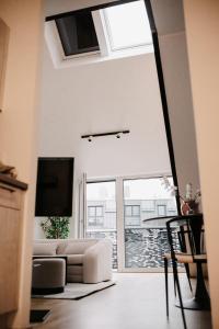 ein Wohnzimmer mit einem Sofa und einem großen Fenster in der Unterkunft Modern Luxury Apartment Vienna in Wien