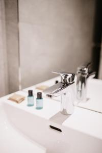 a bathroom sink with a faucet and some toothpaste at Modern Luxury Apartment Vienna in Vienna