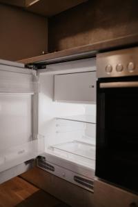 an empty refrigerator with its door open in a kitchen at Modern Luxury Apartment Vienna in Vienna