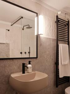 a bathroom with a sink and a shower at Serene retreat in Glyfada in Athens