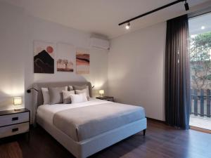 a bedroom with a large bed and a large window at Serene retreat in Glyfada in Athens