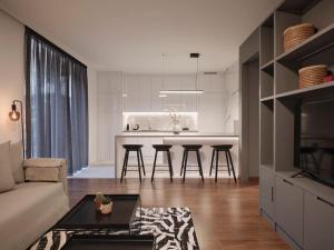 a kitchen and living room with a couch and a table at Serene retreat in Glyfada in Athens