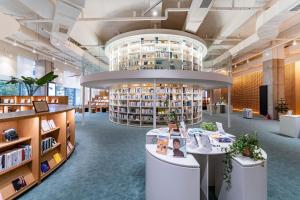 a library with a lot of books on shelves at Brown Suites Busan Station in Busan