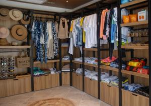 a walk in closet filled with lots of clothes at Stone Beach Club in Dhiffushi