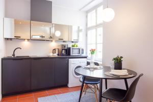 a kitchen with a small table and a microwave at Gildi Apartment in Tartu