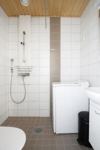a bathroom with a shower and a toilet and a sink at Kotimaailma Apartments Kamppi - 1BR with a key code in Helsinki