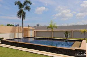 una piscina en un patio junto a un edificio en Wonderland pool villa en Pattaya centro