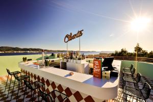 a bar on the roof of a building with chairs at Cubanito Ibiza in San Antonio