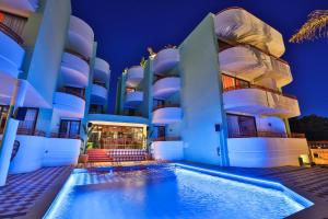 a hotel with a swimming pool in front of a building at Cubanito Ibiza in San Antonio