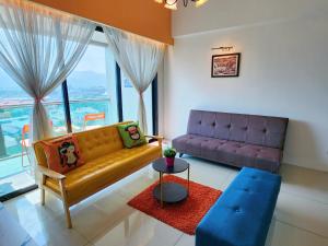 a living room with a couch and a table at Kinta Riverfront Apartment, Jalan Lim Bo Seng Ipoh in Ipoh