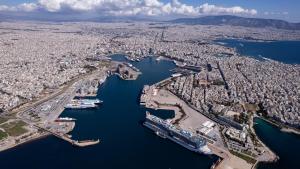 an aerial view of a city with boats docked at Mitsis N'U Piraeus Port in Piraeus