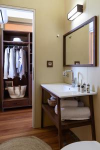 a bathroom with a sink and a mirror at iHouseVILLAGE in Polykhrono