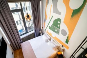 a room with a bed and a window at Limehome Porto Rua da Conceicao in Porto +40 photos