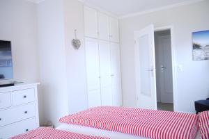 Postel nebo postele na pokoji v ubytování Meeresrauschen-Dünengold