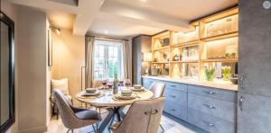 a dining room with a table and chairs in a kitchen at The Lodge, Saxmundham in Saxmundham