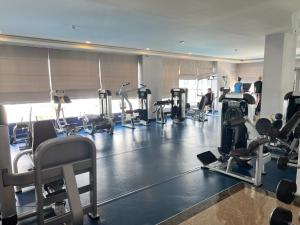 a gym with several tread machines and people in it at Arcadia Beach Resort Condominium in Pattaya South