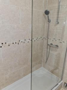 a shower stall with a glass door and a shower constructorangering at Superior Hotel in Dudley