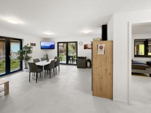 a dining room and living room with a table and chairs at feworld Freilassing - 2 apartments - near train station - free parking in Freilassing