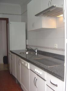 a kitchen with a sink and a counter top at Miramar in Mazagón