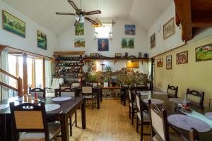 a restaurant with tables and chairs and a ceiling fan at Camping Silva in Ljutomer