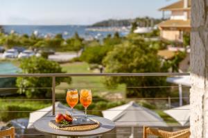 two glasses of champagne on a table on a balcony at Sofibel sivota suites in Syvota