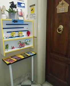 a shelf in a room next to a door at Stella del Sud in Catania