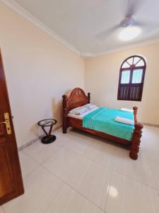 En eller flere senge i et værelse på Home Stay Boutique Zanzibar