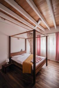 a bed in a bedroom with a wooden ceiling at Chateau de Saint Dau in Figeac