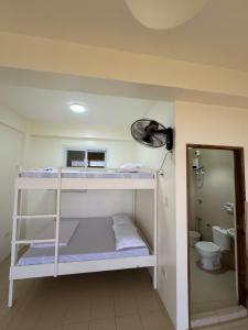 a room with a bunk bed and a toilet at Batman’s Peak baguio in Itogon