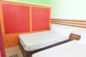 Postel nebo postele na pokoji v ubytování Vaidehi Home Stay